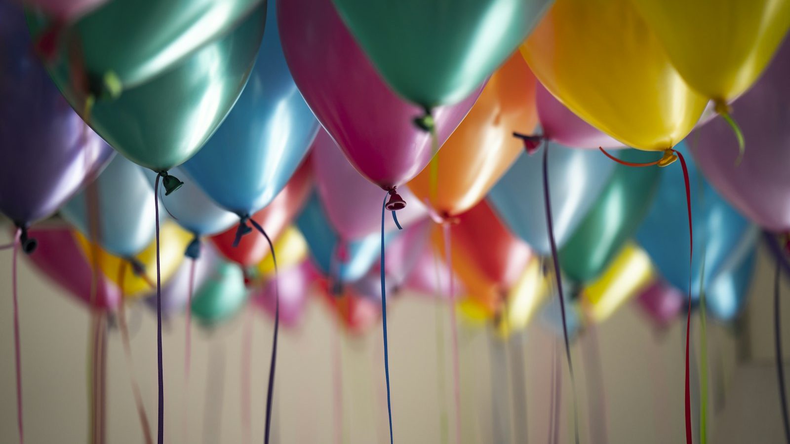 Colourful party balloons with trailing ribbons