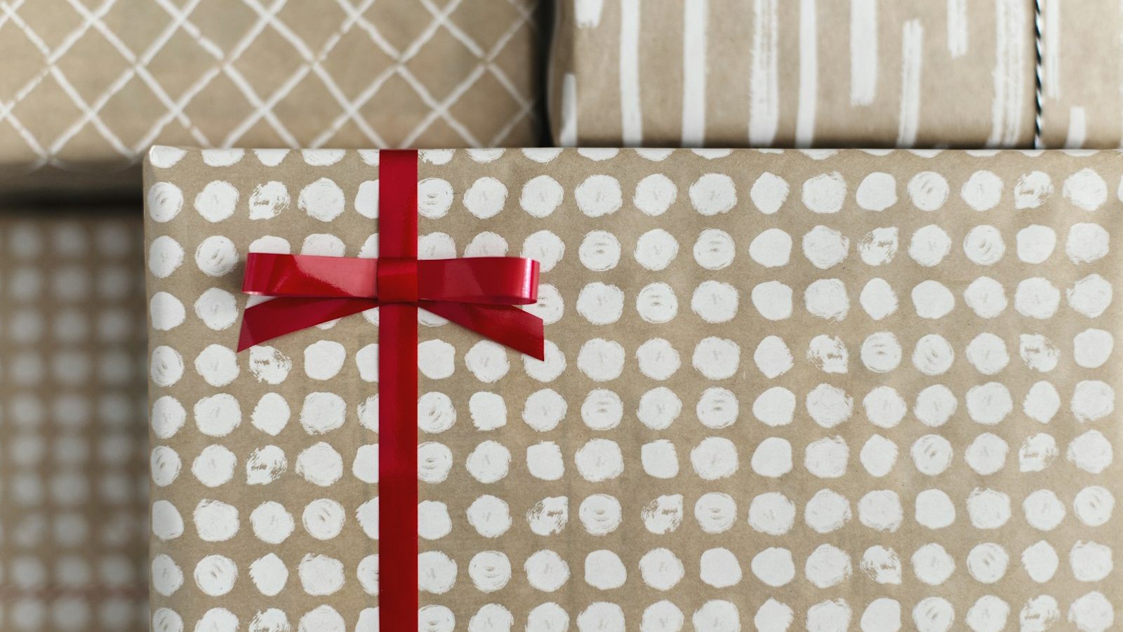 Patterned gift box tied with a red ribbon